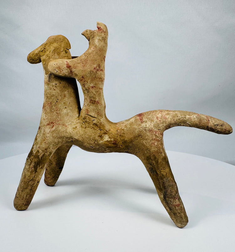 Greek terracotta horse and rider figurine with abstract geometric styling characteristic of Boeotian workshops.