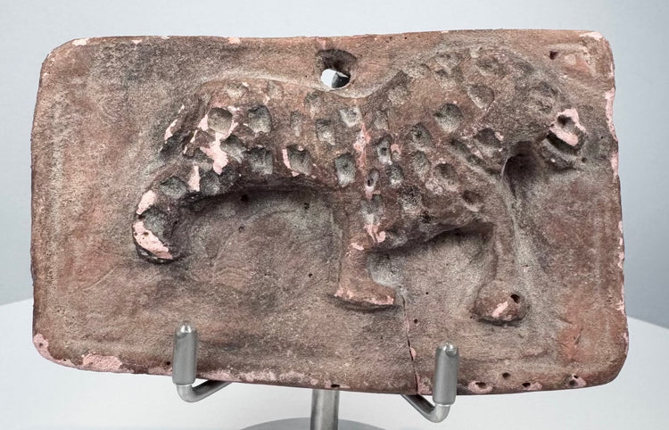 Ancient terracotta plaque from India with probable leopard figure, impressed coat markings, and central age crack.