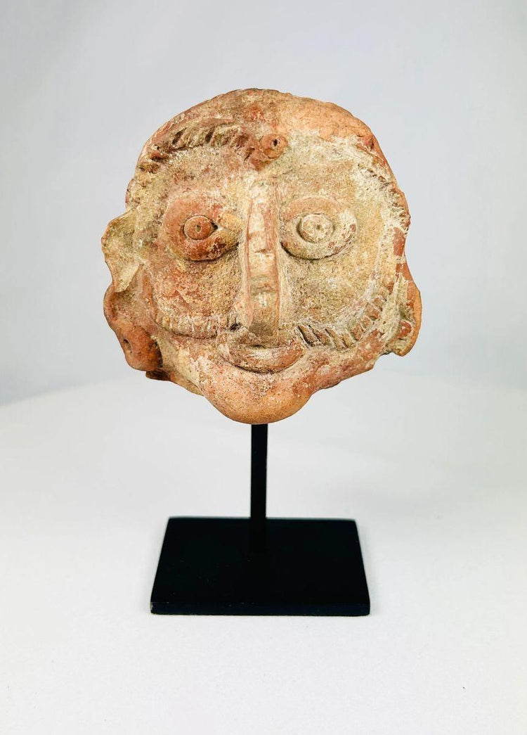 Front view of an ancient Indian terracotta head crafted in red clay during the Shunga period