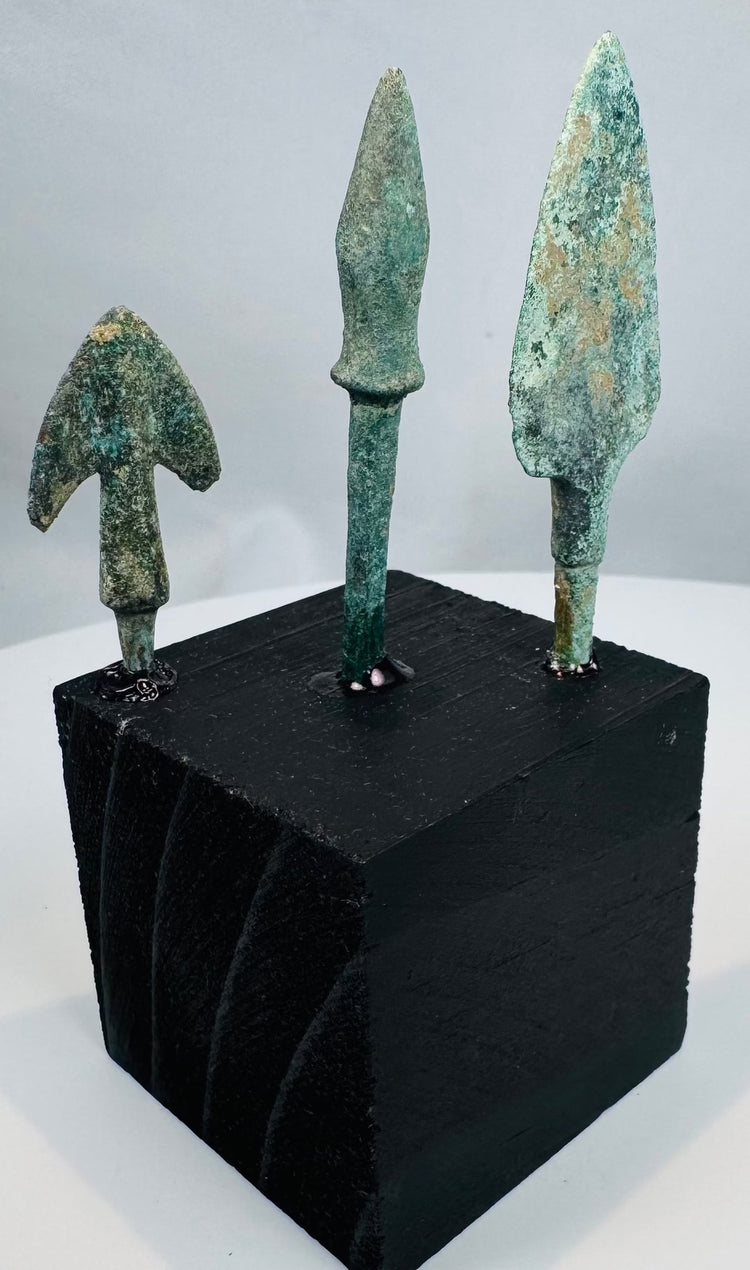 Compact winged bronze arrowhead with swallow-like shoulders and heavy mineral patination