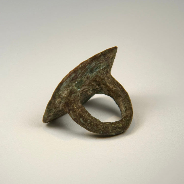 Bronze finger ring with paired bird motif, softened bezel edges, and age-related surface wear