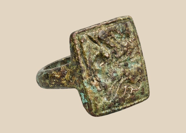 Ancient cast bronze ring with square bezel engraved with twin birds symbolizing harmony and companionship, natural green patina, 1st–5th century CE, Mediterranean or Middle Eastern origin, US size 1.