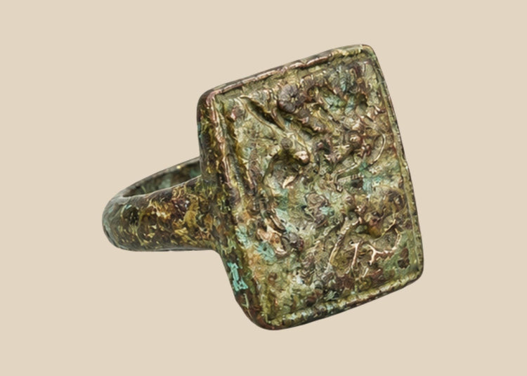 Ancient Mediterranean bronze ring with square bezel and paired bird engraving