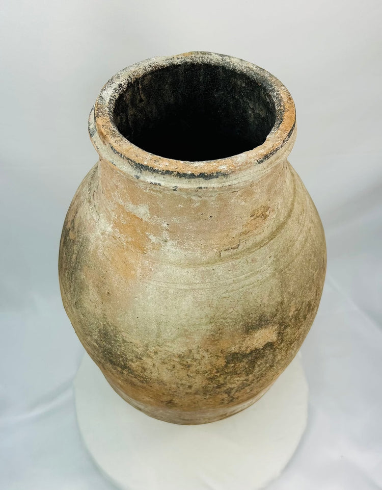Eastern Mediterranean Byzantine ceramic storage jar with olive-shaped body and aged finish