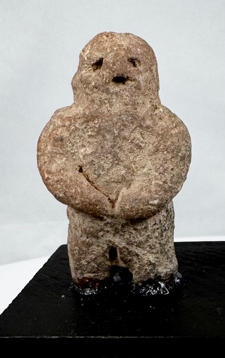 Ancient Mesoamerican stone effigy with abstract human form and weathered surface
