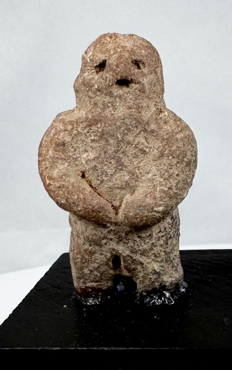 Ancient Mesoamerican stone effigy with abstract human form and weathered surface