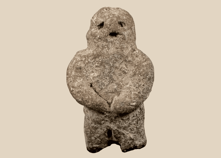 Pre-Columbian carved stone standing figure with folded arms and deeply recessed eyes