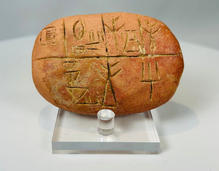 Bronze Age cuneiform tablet with grid layout and wedge shaped markings