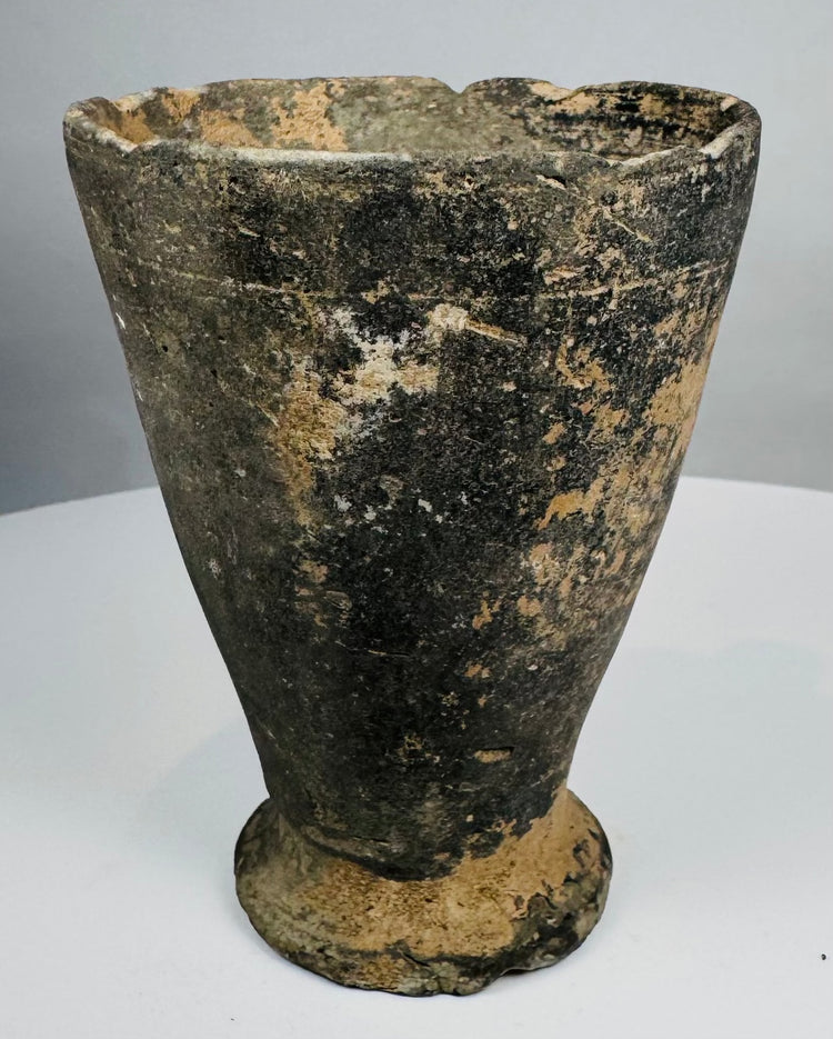 Iron Age ceramic cup with chipped rim and archaeological patina