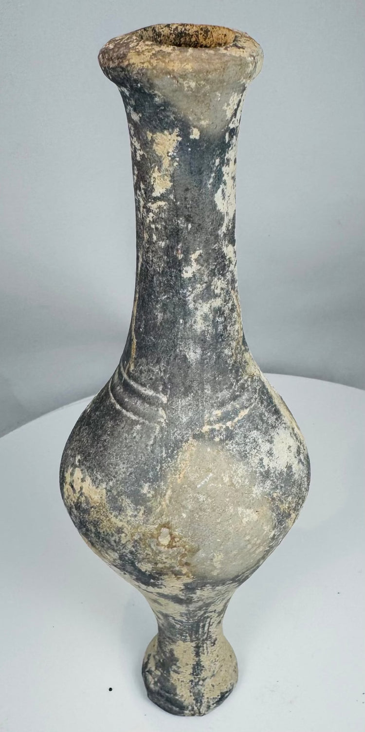 Side view of Iron Age grayware vessel showing tall neck and raised foot