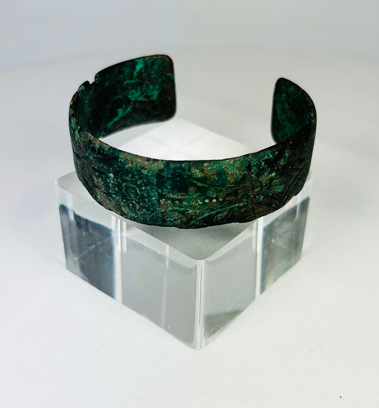 Detail view of incised decoration on ancient Persian bronze cuff bracelet