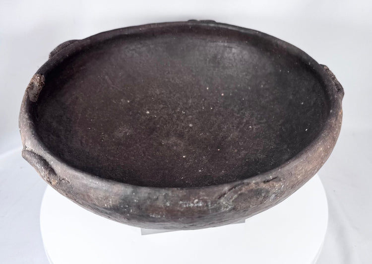 Pre-Columbian earthenware vessel featuring a hemispherical form and fire-clouded patina