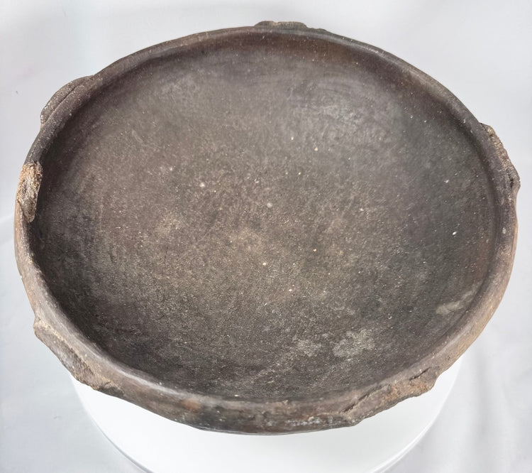 Pre-Columbian terracotta bowl featuring hand-finished irregularities and raised rim elements