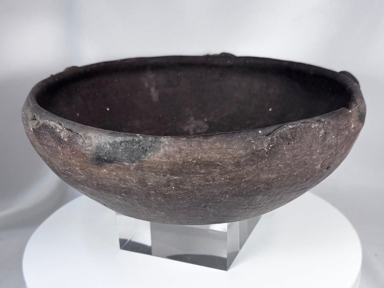 Pre-Columbian ceramic bowl with dark firing coloration and sculptural rounded profile