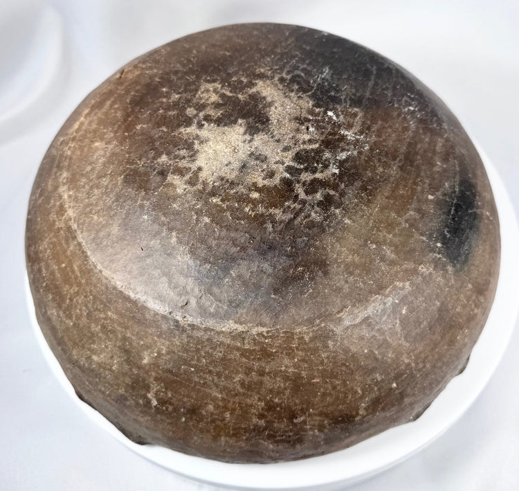 Ancient earthenware bowl with hemispherical body, fire-clouded finish, and aged patina