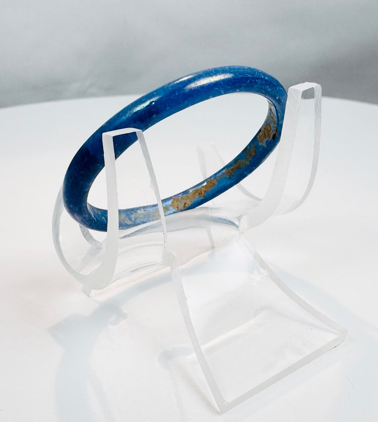 Ancient Roman blue glass jewelry artifact showcasing early glassmaking technology and design.