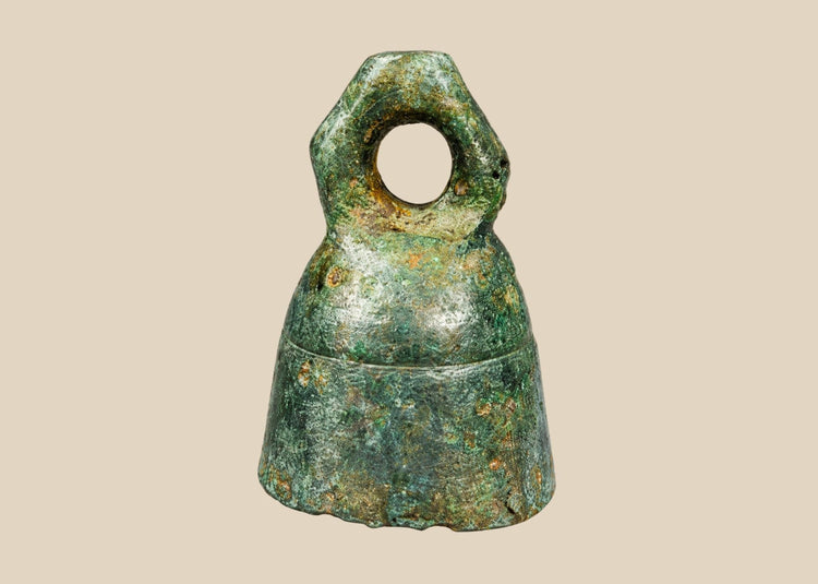 Ancient Roman cast bronze bell, 1st–4th century CE, with suspension loop, rich green patina, and mounted display stand.