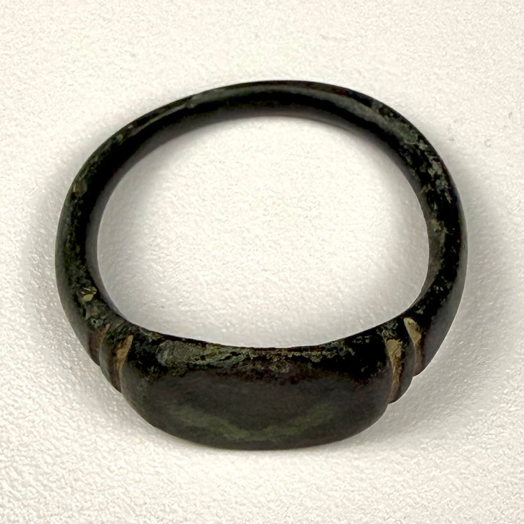 Detail view of Roman Imperial bronze finger ring showing surface pitting, oxidation, and mineral encrustation