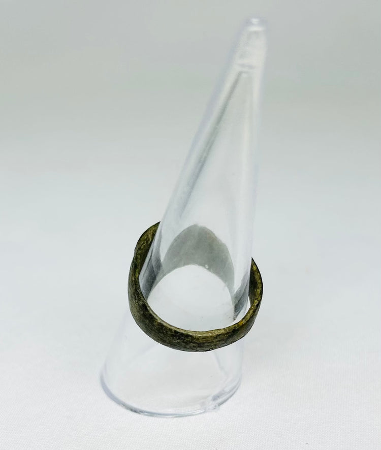 Top view of ancient Roman bronze ring, showing circular bezel and engraved Christogram, 1st–4th Century CE, early Christian artifact.