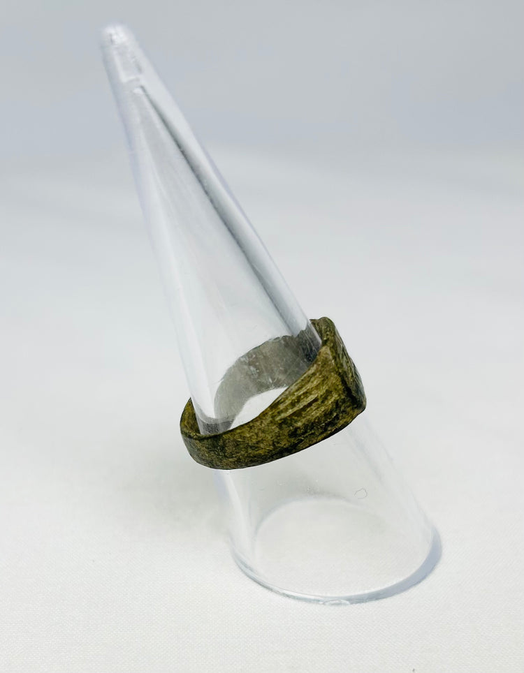 Close-up macro image of Roman bronze ring’s engraving and patina, early Christian Christogram symbol, 1st–4th Century CE.