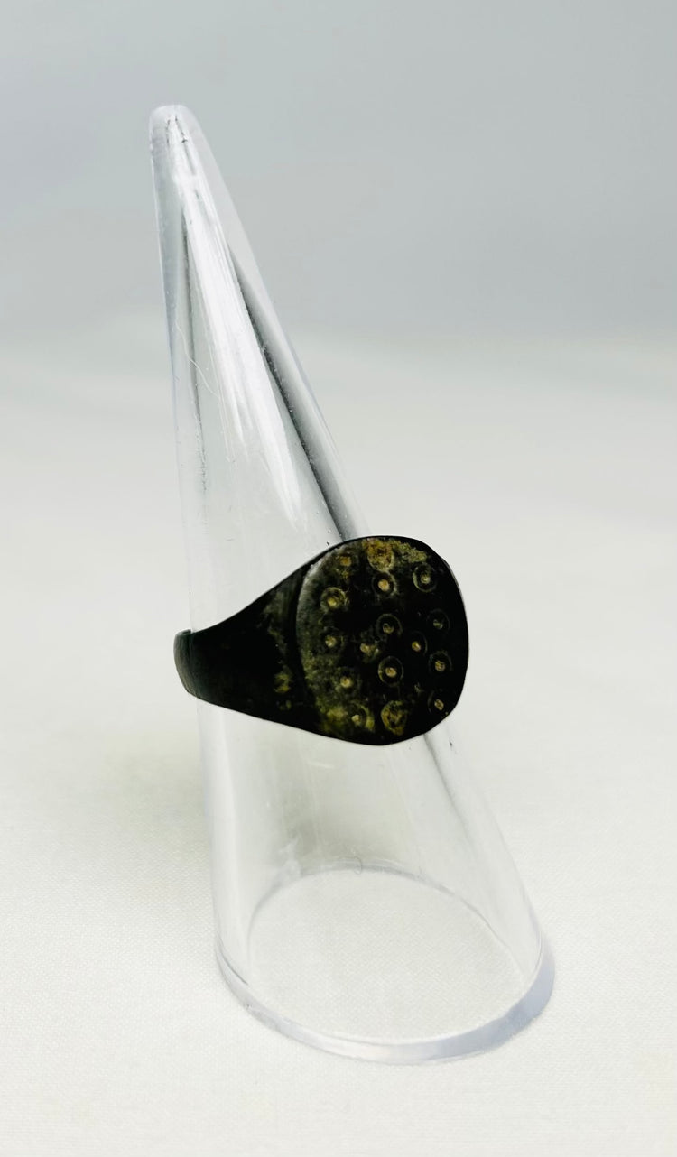 Roman Empire bronze ring with symbolic ring-and-dot solar design, viewed from above