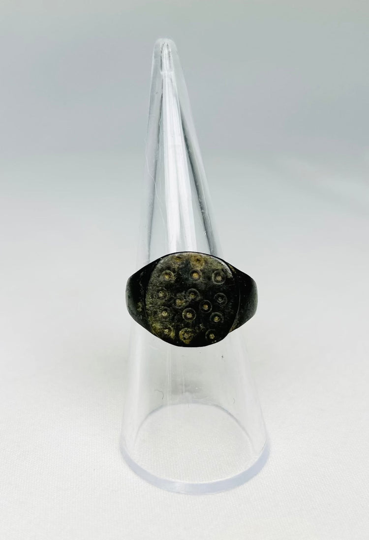 Detailed view of ring-and-dot decoration on a 1st–3rd century Roman bronze ring