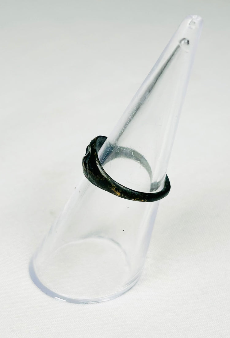 Roman bronze ring with symbolic rodent motif, worn band, and earthen deposits