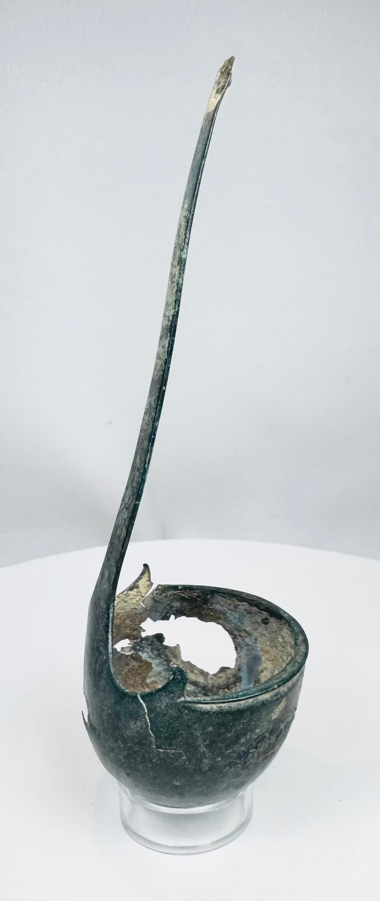Ancient bronze utensil with two raised spur-like projections beside the handle