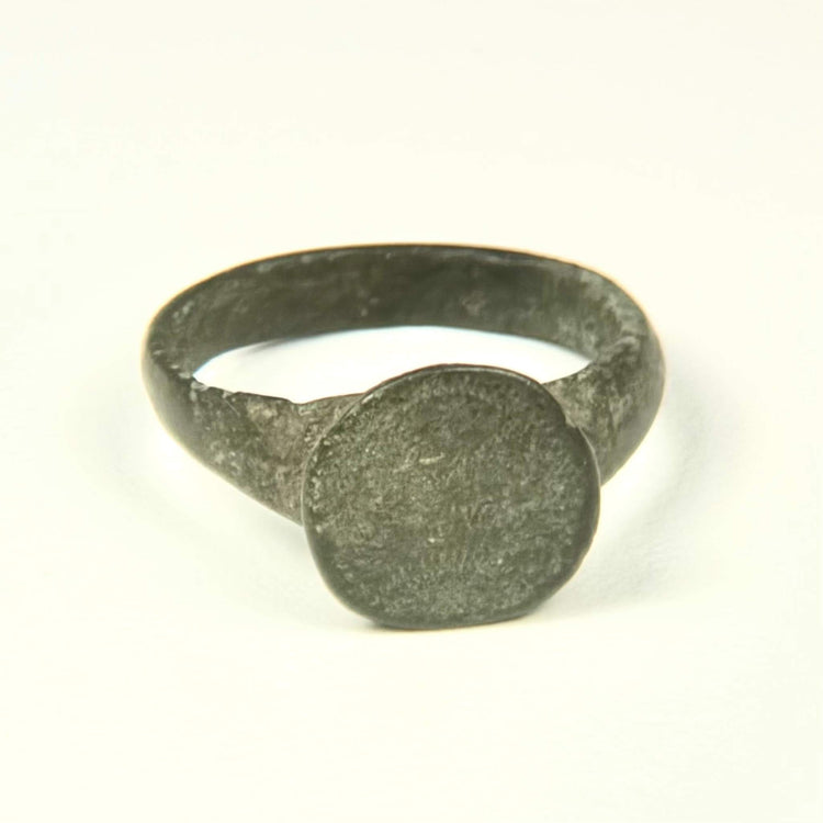 Roman to Early Byzantine bronze ring, US size 8, with broad circular bezel and intact tapered hoop, circa 1st–8th century CE