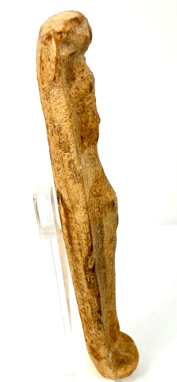 Side profile of elongated Roman terracotta fertility statue showing breast definition