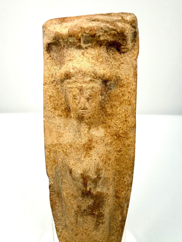 Roman Imperial terracotta votive figurine with faint facial features, an enshrouded body, and centuries of surface wear.