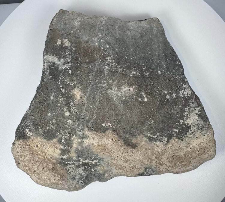 Carved Roman volcanic tuff relief fragment displaying porous stone grain, sculptural erosion and mineral encrustation