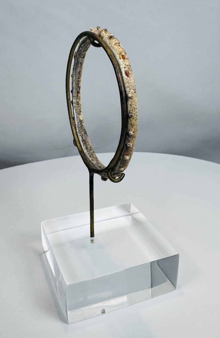 Ancient Roman personal adornment crafted from glass with applied decorative nodules.