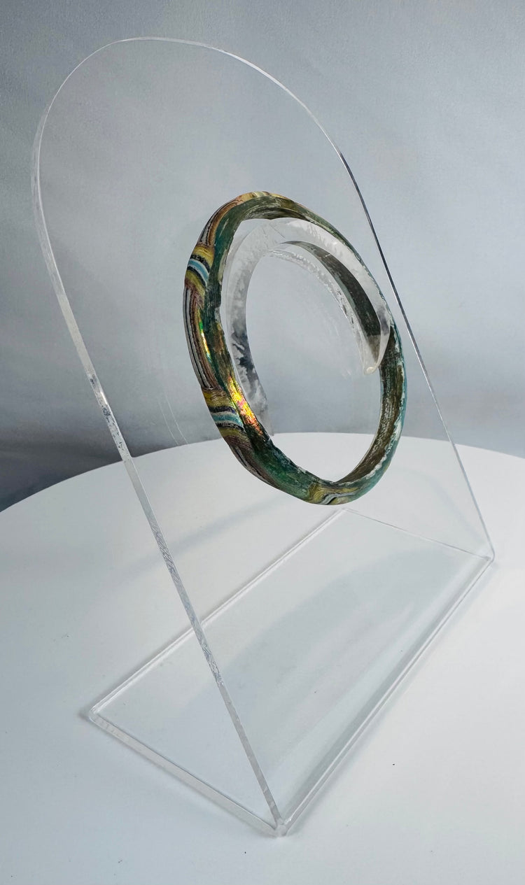 Authentic Roman mosaic glass bracelet featuring multicolored bands of green, yellow, white, blue, and black glass.