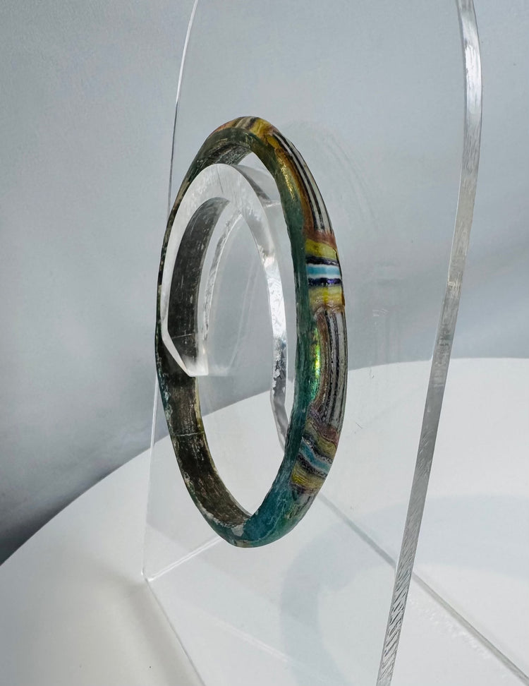 Multicolored Roman glass bracelet with fused glass bands and attractive archaeological weathering.