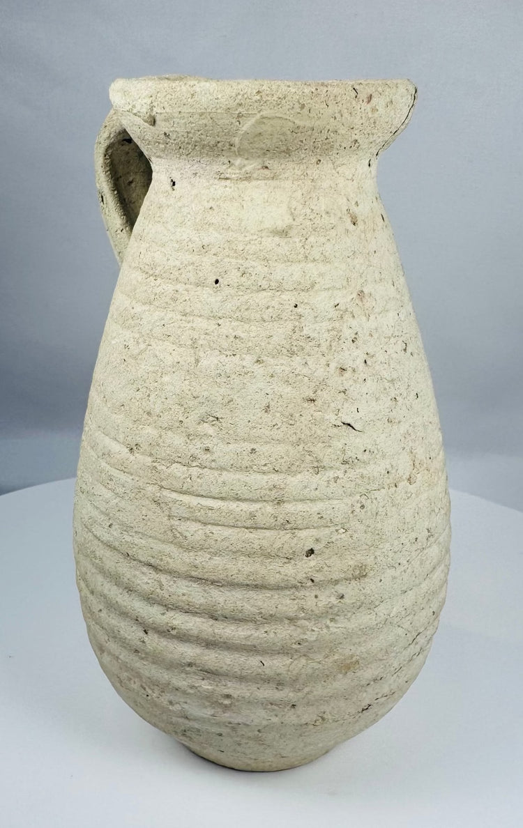 Ancient Roman terracotta pitcher from Africa Proconsularis with ribbed body and flared rim.