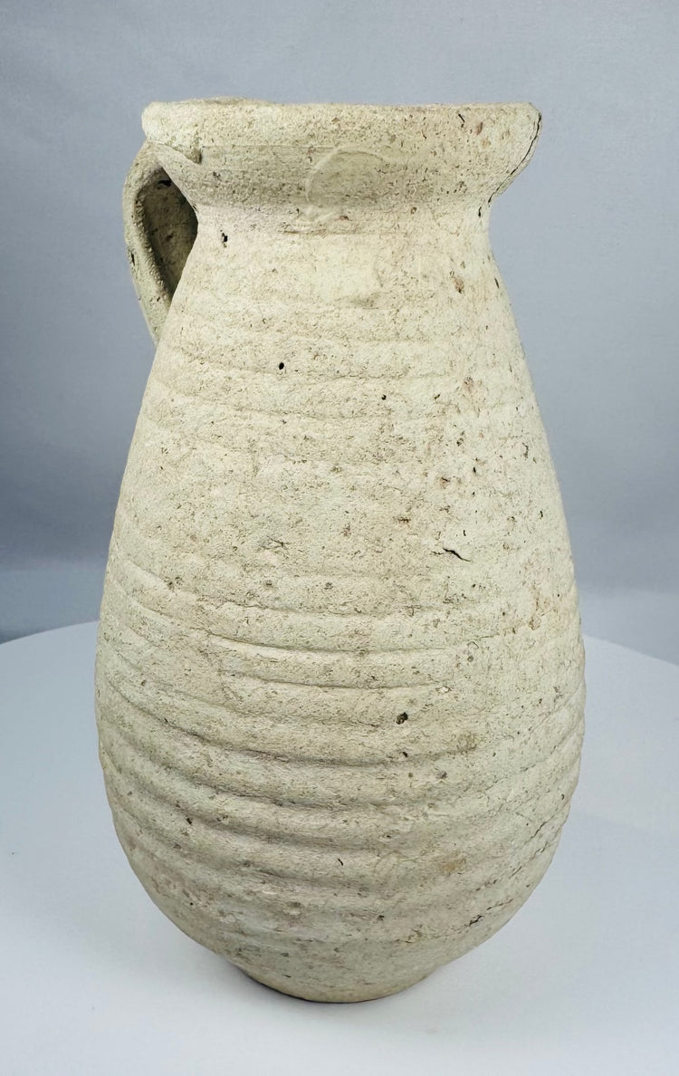 Ancient Roman terracotta pitcher from Africa Proconsularis with ribbed body and flared rim.