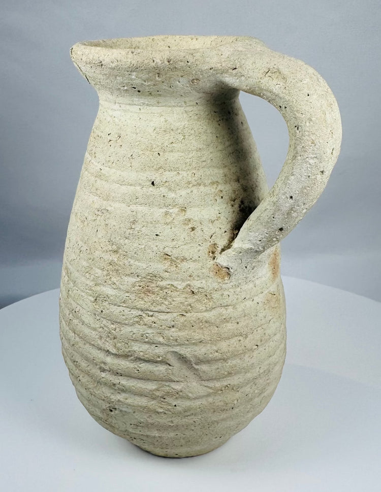 Ancient Tunisian terracotta vessel dating to the Roman Imperial period with a sturdy loop handle.