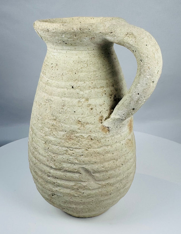 Ancient Tunisian terracotta vessel dating to the Roman Imperial period with a sturdy loop handle.