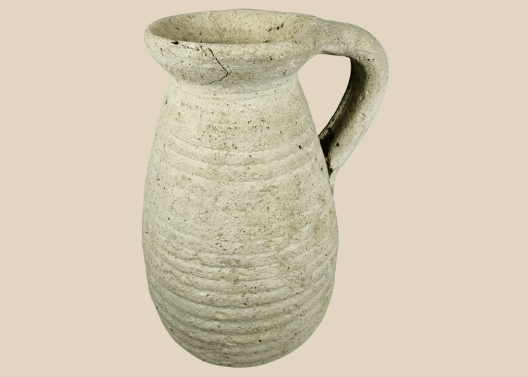 Ancient Roman North African terracotta pitcher from modern Tunisia with ribbed body and loop handle.