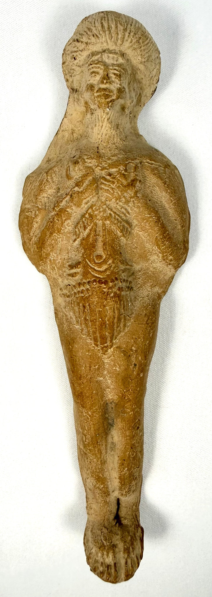 Frontal view of bearded male Roman terracotta figurine with radiating headdress and fused legs
