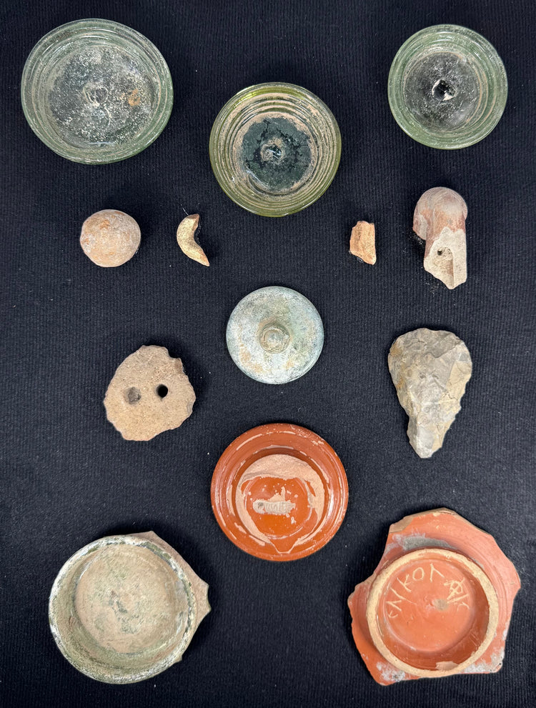 Roman glass vessel bases and terra sigillata fragments mounted in a wooden shadow-box frame