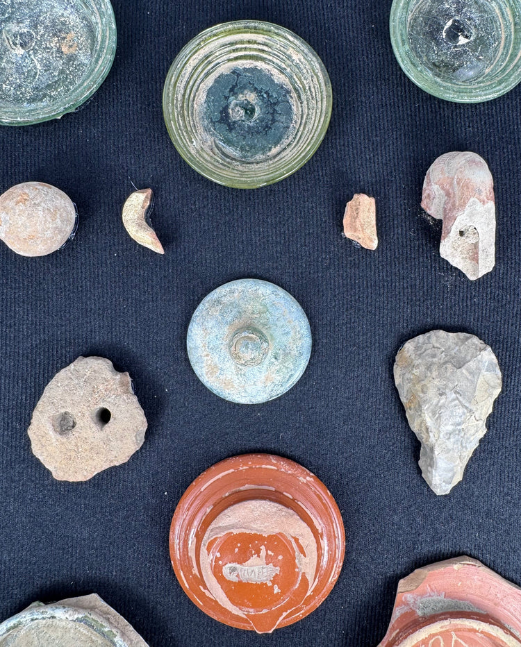 Close-up of Roman yellow-green glass bases with iridescence and concentric-ring decoration
