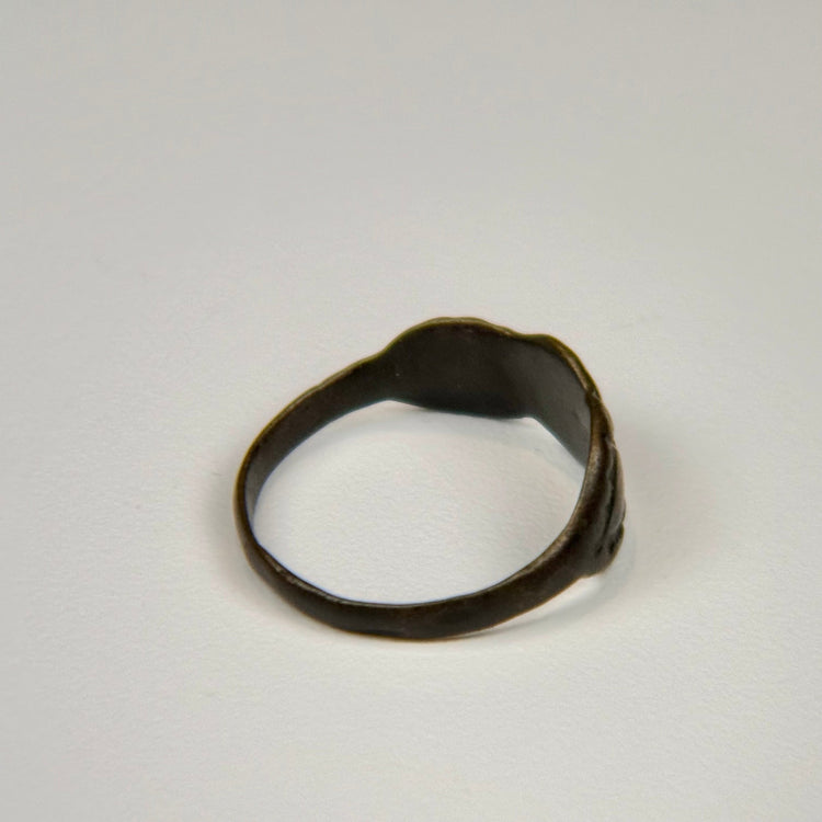 Ancient silver finger ring showing a weathered clustered bezel and centuries-old natural patina