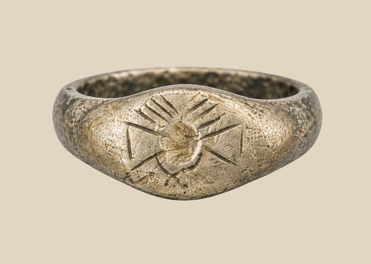 Ancient silver signet ring with engraved sunburst motif