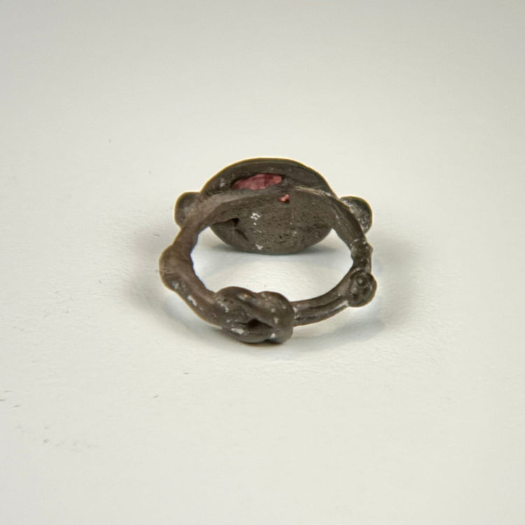 Ancient silver intaglio ring showing the circular band, aged patina, and elevated garnet bezel