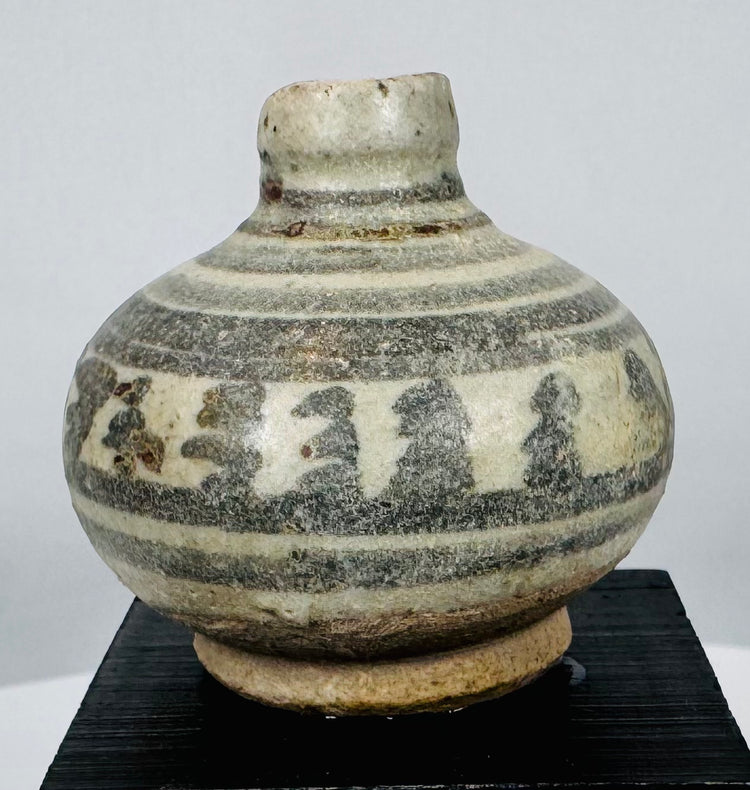 Medieval Thai glazed stoneware vessels with hand-painted geometric and floral designs characteristic of Sawankhalok ceramic production.
