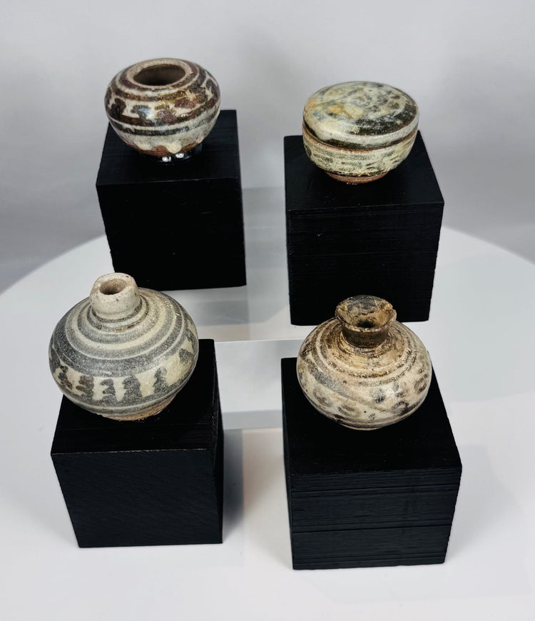 Ancient Sawankhalok miniature pottery vessels from Thailand, featuring fine stoneware construction and underglaze painted details.