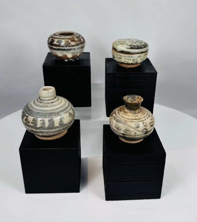 Ancient Thai Sawankhalok ceramic vessels with iron-black painted motifs beneath a transparent glaze, dating to the 14th–15th century CE.