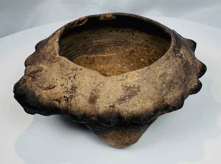 Rare ancient West Mexican ceramic tripod bowl displaying three hollow supports and stylized zoomorphic head decoration.